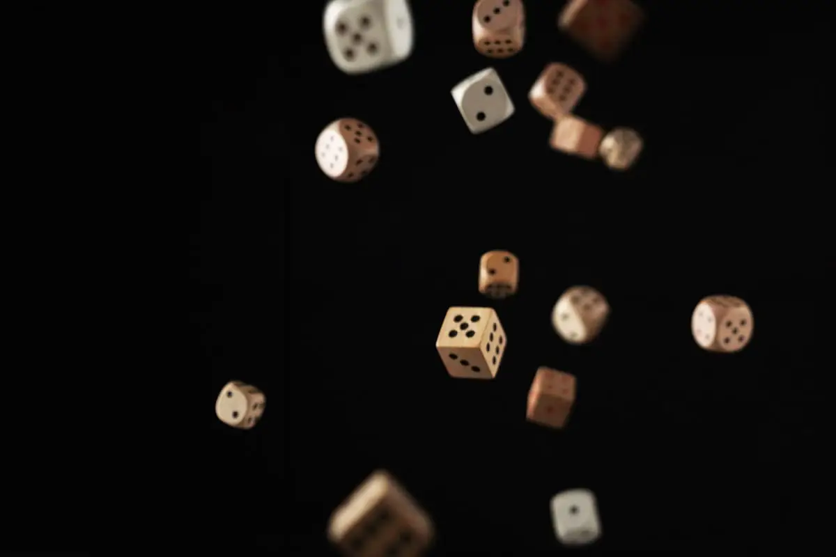 Dice falling against a dark background